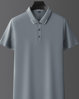 Polo grigia elegante su sfondo grigio, con colletto e bottoni, perfetta per look casual e formali. Maglietta uomo moda 2023.